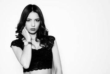 beautiful young woman with long black hair and wrist watch posing on white background