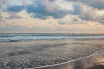 Serene Beach Scene Under a Cloudy Sky, summer concept.