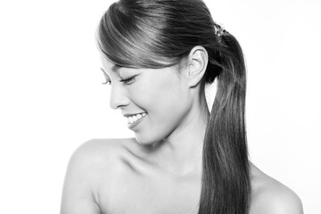 Beautiful asian woman with long dark and healthy hair and clear skin