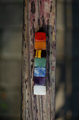 A set of colored stones in the seven chakras, for meditation on the wooden beam