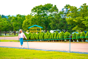 Asian little girl walking in the park. Environment concept. Childcare.Lifestyle.