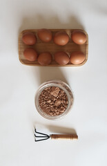 Eggs, Cocoa Powder, and Gardening Tool Arrangement