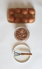 Farm Fresh Eggs, Cocoa Powder, and Gardening Tool Arrangement