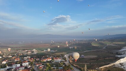 Aerial View of Hot Air Balloons Over Pamukkale Travertines and Town in Turkey