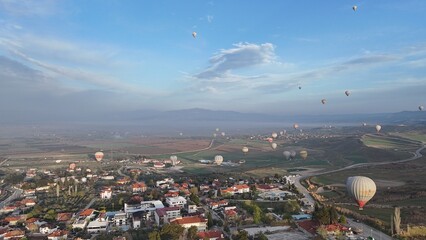 Aerial View of Hot Air Balloons Over Pamukkale Travertines and Town in Turkey