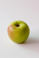 One fresh green apple on a white background