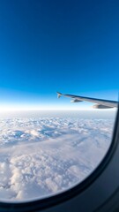 Fototapeta premium High-altitude view of fluffy clouds from an airplane window.