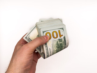 USA dollars, US money, cash, salary in dollars, dollar, mans hand is holding a stack of US dollars,...