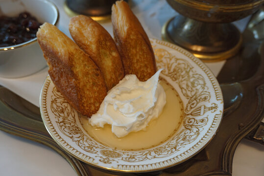 toasted bread with kaymak cream and honey on a plate, turkey breakfast