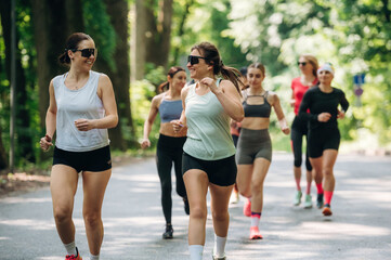 Fototapeta premium Activity, healthcare conception. Group of runners are together outdoors