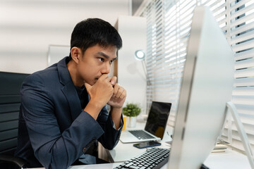 stressed asian businessman working in the office.	