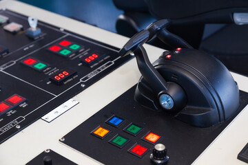 A control panel for a sea ship with various buttons, levers and switches.
