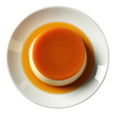 Overhead view of exquisite creme caramel dessert with caramel sauce on a white plate transparent background