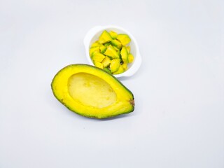 A vibrant image featuring a halved avocado alongside a bowl of chopped avocado. Perfect for...