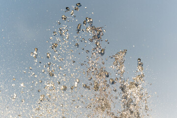 Splashes and jets of water against light background.