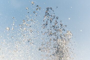 Splashes and jets of water against light background.