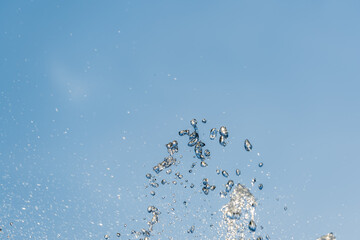 Splashes and jets of water against light background.