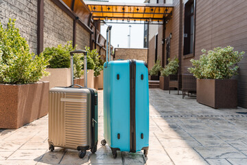 Suitcase near the hotel entrance in summer, travel concept