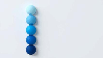 Gradient blue spheres lined up on white background

