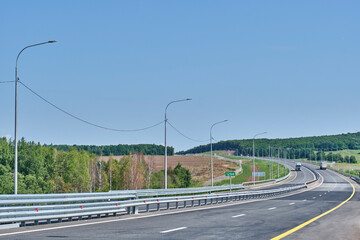 Modern highway through countryside. M-12 East Highway, Dyurtyuli – Achit section, Russia