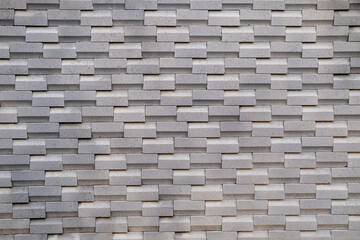 Modern gray brick wall with 3D layered texture, perfect for use in architecture, construction,...