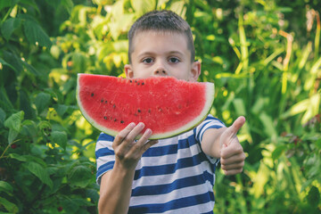 Happy boy eating watermelon. Summer