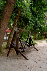 Large wooden swing in the park
