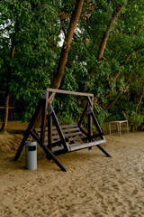 Large wooden swing on the beach