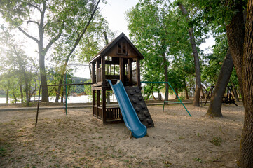 Children's playground with a view of the house and slide in the park