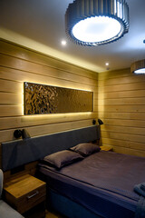 Hotel room with wooden interior, bed and night light