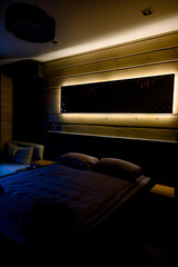 Hotel room with wooden interior, bed and night light