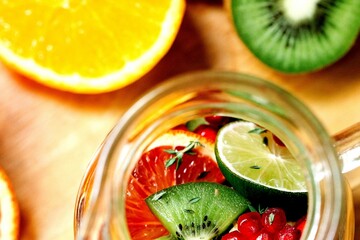 a glass jar filled with a mixture of fruit and veg