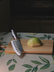 Cutting onion on wooden board