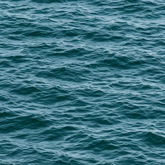 Fototapeta premium Ocean water surface with gentle waves in teal. Perfect for use in nature, travel, and advertising.