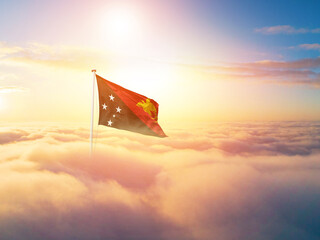 Papua New Guinea national flag aerial view clouds in beautiful sky. Top view. Drone. Aerial bird's eye fly flag. Aerial top flag view cloudscape. Flag with Sunrise or sunset over clouds.