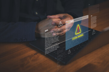 Close-up of male hands on laptop with virtual system warning alert, symbolizing cybersecurity threat, data breach risk, and urgent IT security system notification.