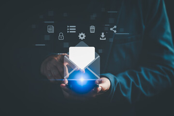 Person using smartphone with digital email icon and communication symbols, representing online...