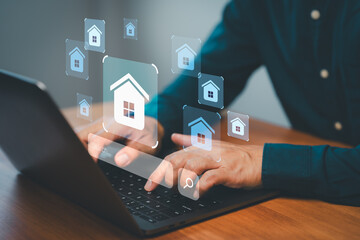 Hands typing on laptop with virtual home search icons, representing online real estate browsing,...