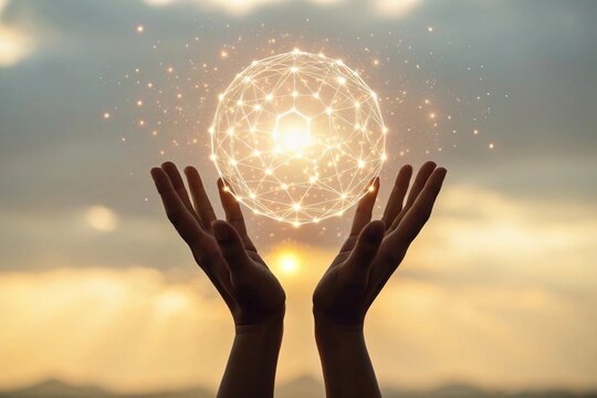 Hands holding glowing digital sphere against sunset sky