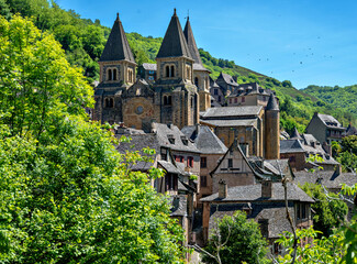 View of historic buildings and the Abbey of Sainte-Foy in Conques in the region Perigord, France
