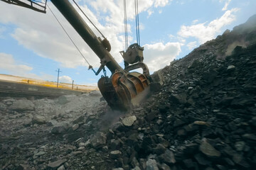 Picking and filling with an excavator bucket of crushed stone fr