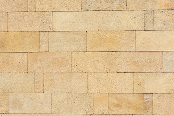 Yellow brick wall texture. House stone wall texture background. Stone wall as background or...