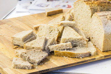 Pieces of fresh traditional wheat or rye bread on stall or in bakery