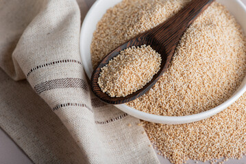 Raw organic amaranth grain. Amaranth seeds in a bowl on wooden table.	