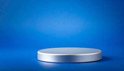 Round silver display podium against deep blue gradient background. Pedestal for presentation.