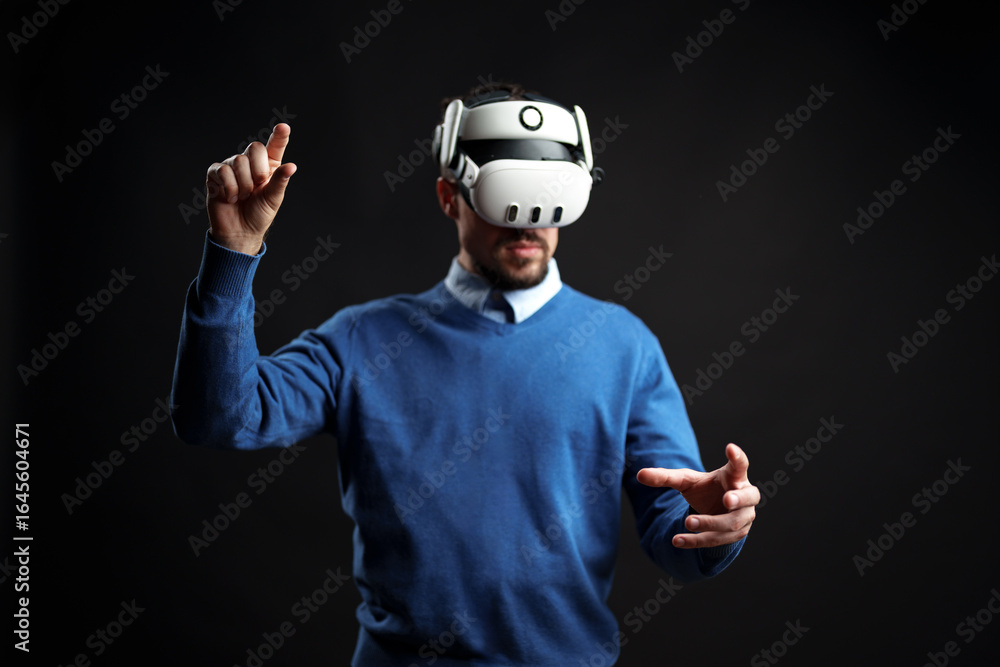 Poster user engages with virtual reality technology while wearing a headset, showcasing interaction and imm