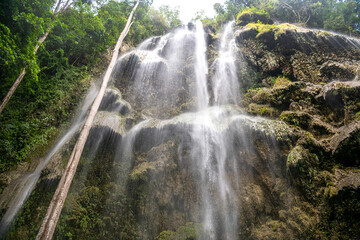 Bottom view on the Amazing secret waterfall with blue turquoise water. Tumalog