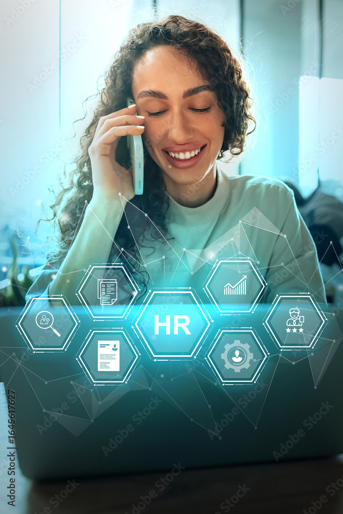Poster employee engaged in hr tasks while on a phone call in a modern workspace during daytime