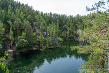 Fototapeta premium Talkov Kamen or Talkov Stone is flooded quarry that formed lake in Sysert district, Sverdlovsk region, Russia. Bazhovskie Places Natural Park. Abandoned talc mine