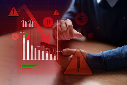 Financial market analysis showing declining trends on a smartphone screen with warning icons in a modern setting
